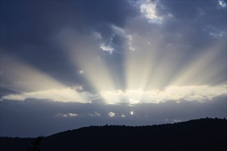 Dramatic sky with sunbeams breaking through, Spessart, Germany, Europe