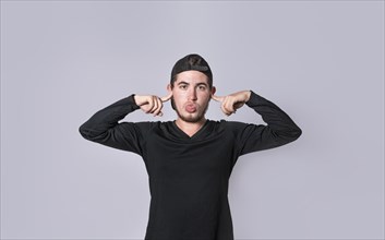 Man covering his ears isolated, guy covering his ears on isolated background, man with hands on his