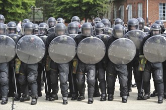 Demonstration of riot squad forming a protective barrier with riot shields during open day of the