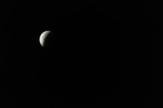 The moon with a partial lunar eclipse, taken in the Swiss mountains, Switzerland, Europe