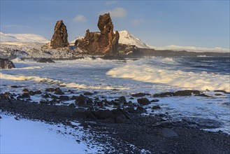 Rocks and surf on the coast, evening light, sun, snow, winter, Arnarstapi, Snaefellsnes,