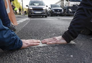 Activists of the Last Generation have taped their hands on a street, Berlin, 24 04 2023