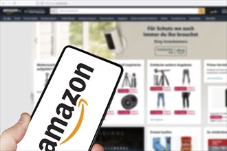 Amazon logo online marketplace online trading ecommerce on a mobile phone and computer in