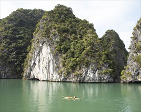 Yellow kayak and the karst rocks in Lan Ha Bay, Halong Bay, Vietnam, Asia