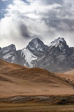 Dramatic mountain landscape with yellow meadows, mountain peaks, Keltan Mountains, Sary Beles