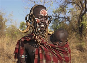 South Ethiopia, in Maco National Park, Mursi tribe, Mursi woman with baby, painted skin and