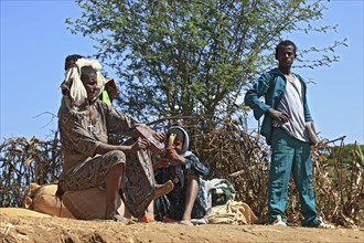 Ahamra region, local family waiting at a boat landing stage, Ethiopia, Africa