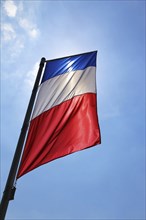 French national flag in front of a blue sky