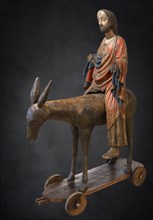 Palm tree donkey, wooden figure from around 1380, painted on a dark background, Hohenzollerisches