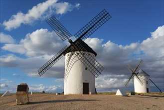 Windmill in a rural setting under a blue sky with dramatic clouds, windmills, Campo de Criptana,