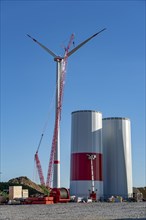 Assembly of a wind turbine, the last rotor blade is being mounted, mobile crane, wind turbine from