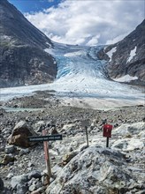 Glacier Steindalsbreen, glacier tongue, signpost and 'trimkassa' at end of valley Steindalen,