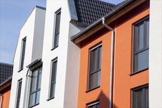 Apartment block with beautiful façade painting in white and Mediterranean orange tone