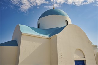 Close-up of a white church with a blue dome under a blue sky, Church of Profitis Ilias, above