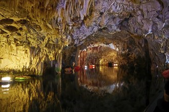 Cave interior with water, stalactites on the ceiling and boats, stalactite cave, Diros Cave,