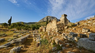 Ruins of ancient structures under a blue sky surrounded by Mediterranean vegetation, Archaeological