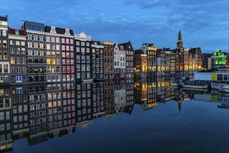 Canal houses on the Damrak, in the centre of the old town of Amsterdam, harbour, starting point of