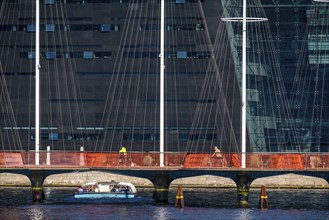 Cyclists on the Cirkelbroen cycle and footpath bridge, over the harbour, in the Christianshavens