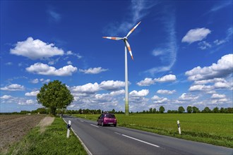 Wind turbine, wind energy plant from the manufacturer Enercon, blue sky with many white clouds,