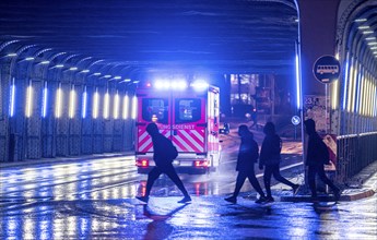 Ambulance on alarm, DRK, Essen fire brigade, rainy weather, city centre, evening, Essen, North