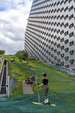 CopenHill, waste incineration plant and artificial ski slope, skiing with a view of the ski lift,