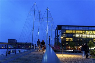 Cyclists on the Cirkelbroen cycle and pedestrian bridge, over the harbour, in the Christianshavens