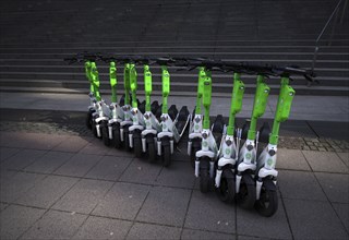 Several electric scooters parked at Lime, OnLime and Uber bike hire, Frankfurt am Main, Hesse,