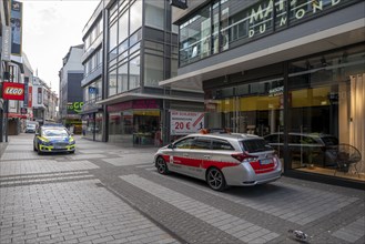 Effects of the coronavirus crisis, empty shopping street, patrol from the public order office and