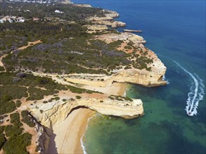 Aerial view of a rocky coastline with clear water and sandy beaches, Albandeira, Lagoa, Algarve,