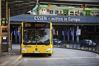 Essener Verkehrsbetriebe bus at the main railway station with local train, public transport,