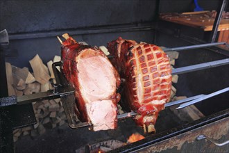 Pieces of pork are grilled on a spit over a wood fire, a speciality in Prague, Czech Republic,