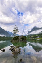 Hintersee with rocks and trees in the foreground, surrounded by mountains, cloudy sky, Ramsau,