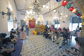 Indian visitors in the interior of the Paradesi Synagogue, Matancherry, Jewish Town, Kochi, Kerala,