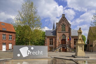 Former city hall in neo-Gothic style and statue of Gabriel Mudaeus on the town square in the