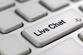 Close up of live chat key on white keyboard. Close up of wind mill turbine covered in ic ein