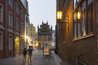 A street illuminated with lanterns leads to the town hall in Stralsund, 12/09/2016