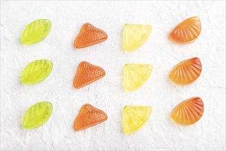 Various fruit jelly candies on gray concrete background. top view, flat lay, close up