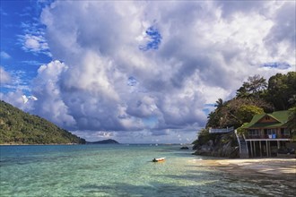 Green tropical island, cloudy sky and small resort.Malaysia