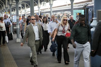 Crowd of passengers leaving their trains on the platform at Norwich railway station, Norfolk,