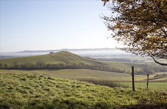 Picked Hill chalk outlier landscape misty valley floor, Vale of Pewsey, from Woodborough Hill,