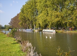 Boats on the River Thames in autumn at Lechlade on Thames, Gloucestershire, England, UK