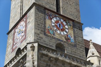 Close-up of a church tower with a large clock and colourful frescoes, Black Church, Old Town,