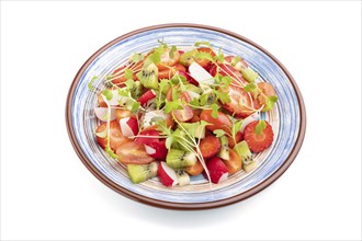 Vegetarian fruits and vegetables salad of strawberry, kiwi, tomatoes, microgreen sprouts isolated