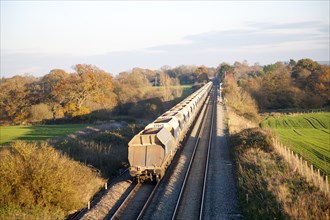 Open waggons of freight train on the West Coast mainline at Woodborough, Wiltshire, England, UK