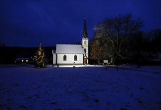 A Christmas tree stands in front of the smallest wooden church in Germany, Elend, 29 December 2020