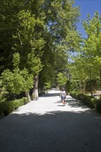 Woman walking in the gardens of the Balneario de Granada hotel, Alhama de Granada, Spain, Europe