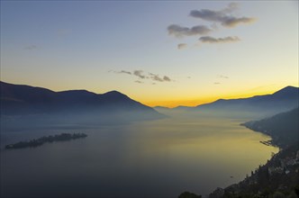 Aerial View over Alpine Lake Maggiore with Fog in twilight with Brissago Islands and Mountain in