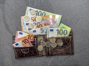 Symbol photo cash money banknotes euro banknotes coins coin money euro coins swells out of wallet