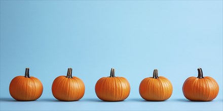 Orange pumpkins in a row on light blue background. Generative Ai, AI generated