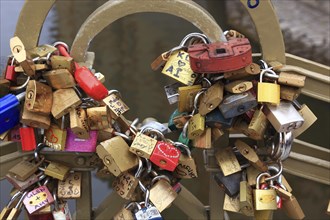 Lover's lock on a railing, love lock is a padlock which, according to custom, is attached to